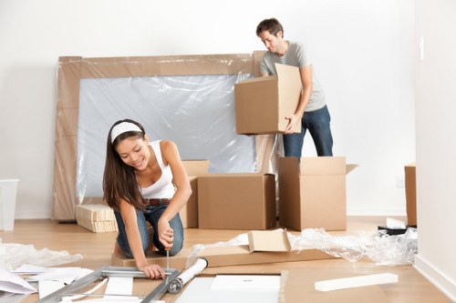 Pentonville apartment moving team carrying furniture through a narrow hallway