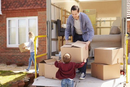 Team member handling moving equipment safely during a house move