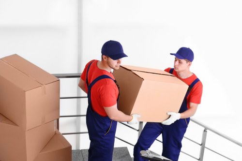 Person loading moving boxes into a van for a removal service
